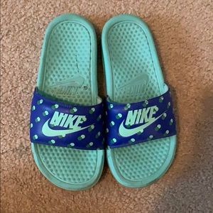 Blue and green Nike slides